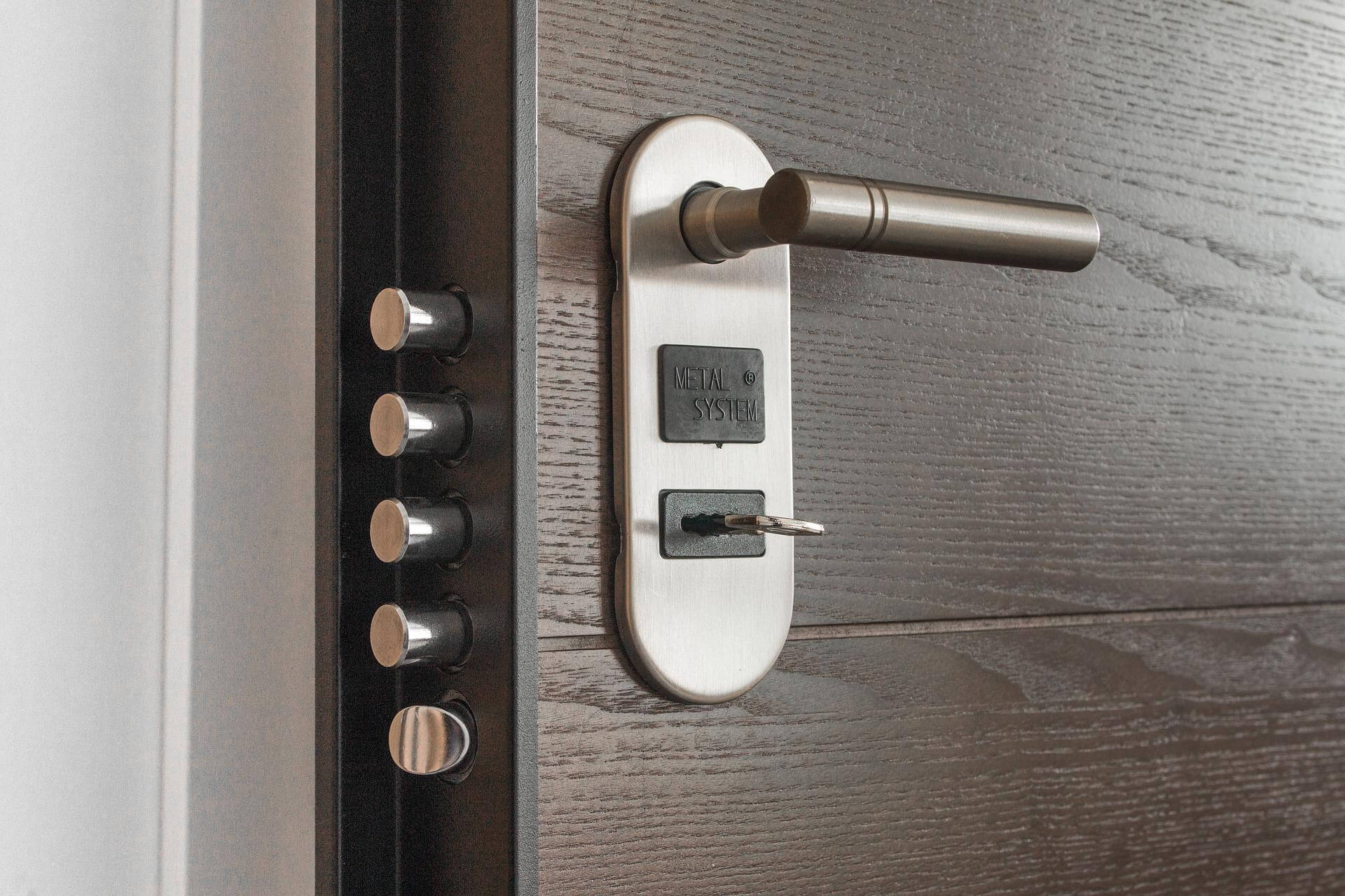 A hotel door with large locking mechanisms