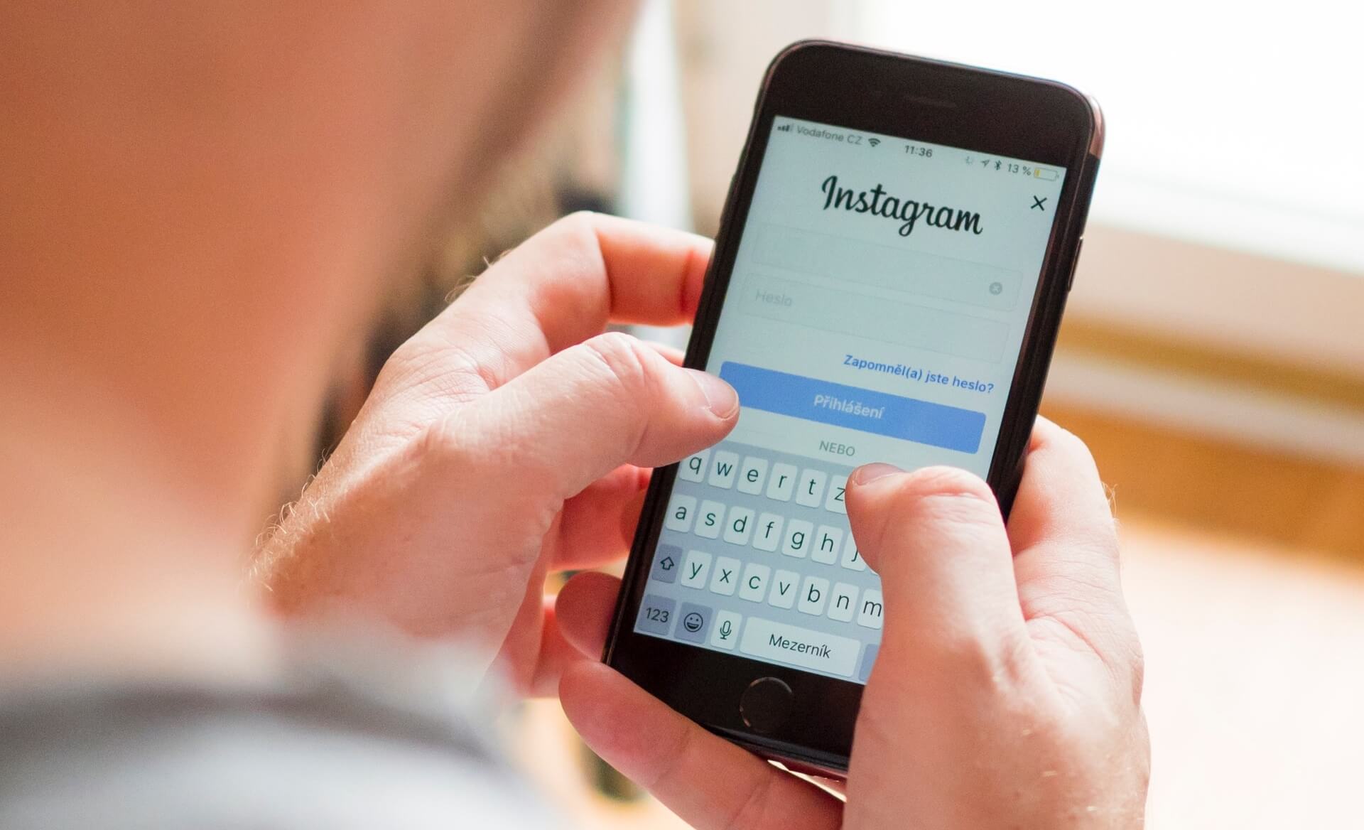 A man logs into Instagram on his cellphone