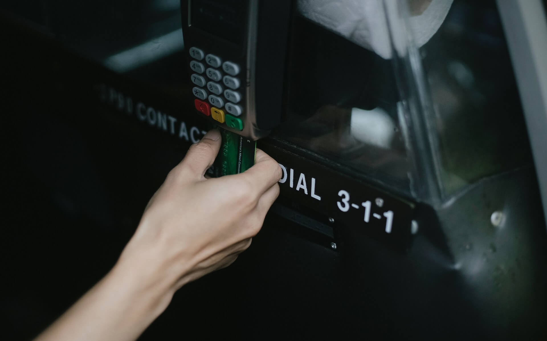 A person inserts their credit cared into a card reader