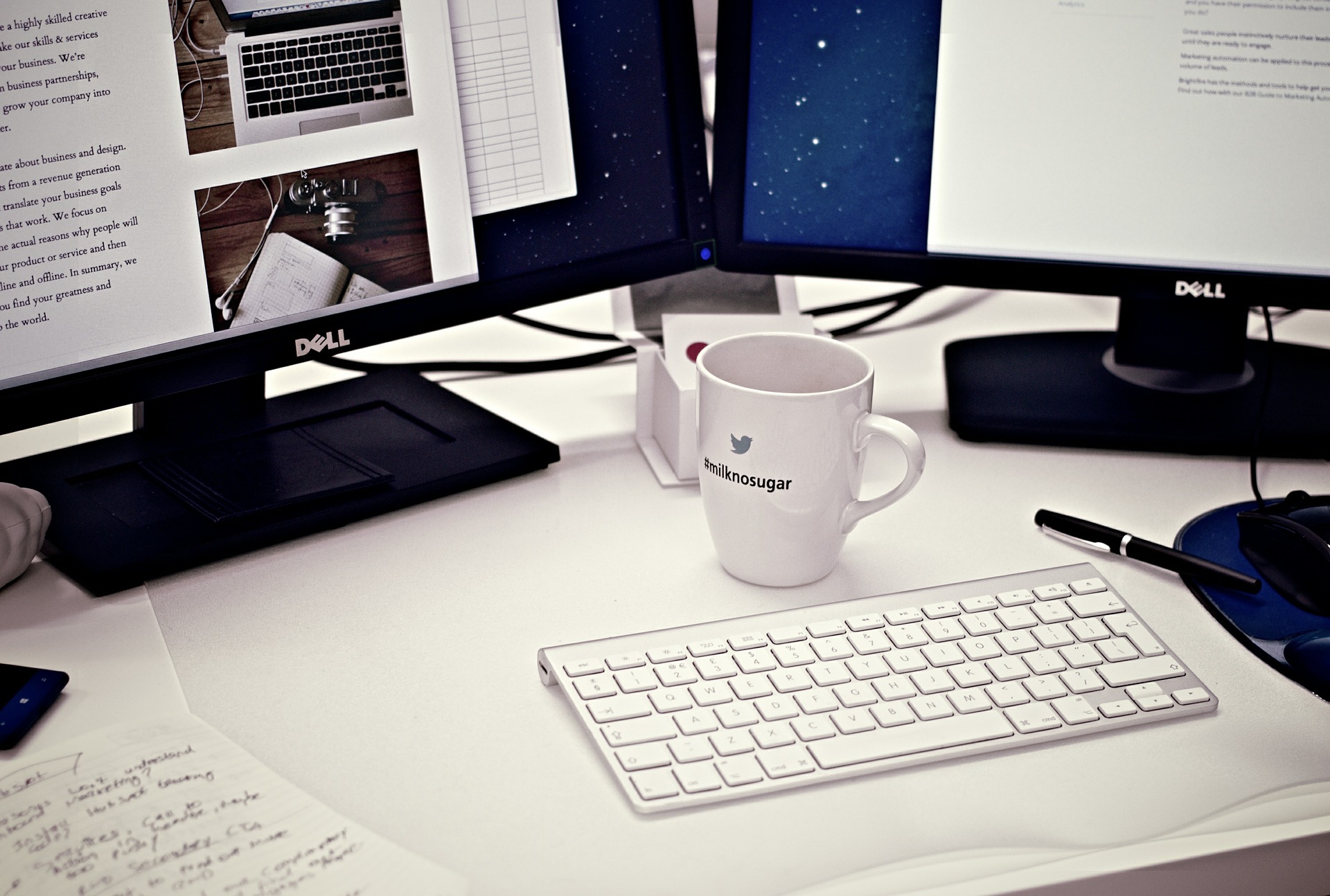 A workstation with a white coffee mug